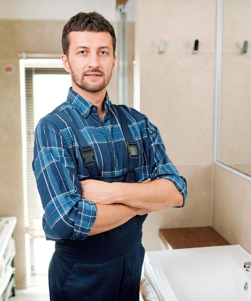 young-successful-plumber-in-workwear-standing-in-b-resize.jpg